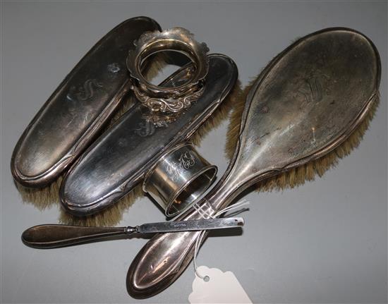 Four silver mounted dressing table items and two silver napkin rings.